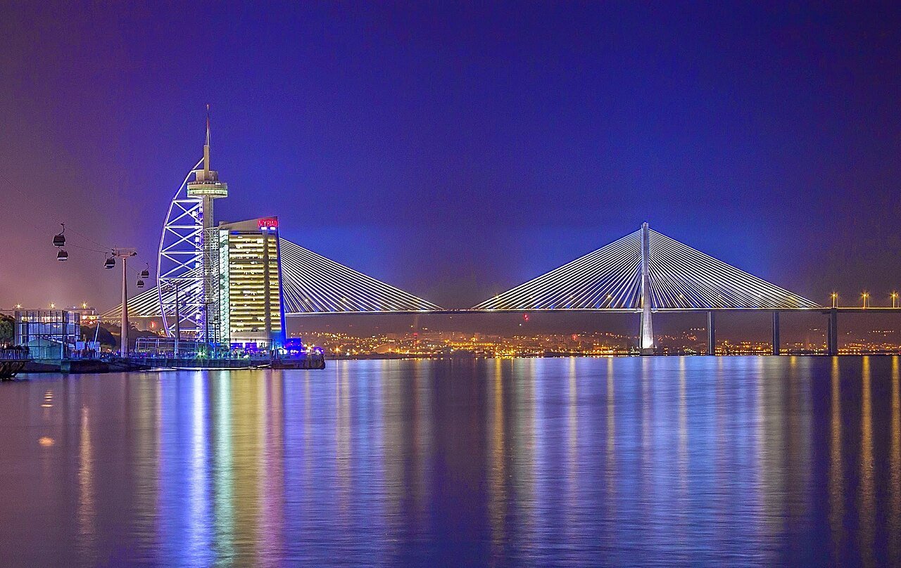 Parque das Nações and the Vasco da Gama Bridge at night in Lisbon, Portugal, a modern district where many families with a Portuguese NIF settle