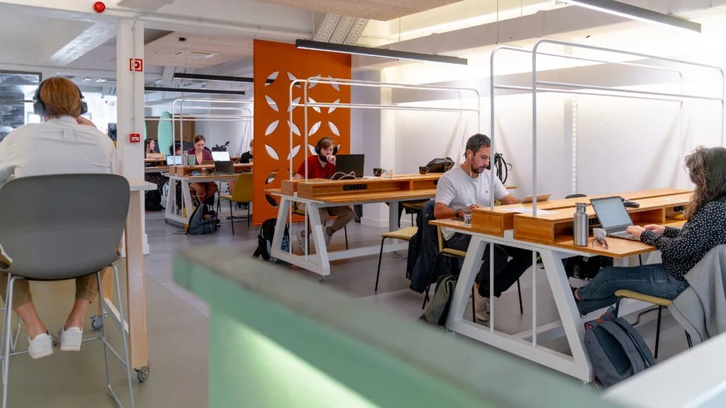 People working at desks in a Lisbon office in Portugal, the workplace where a Portuguese NISS social security number is used for employment contracts and contributions