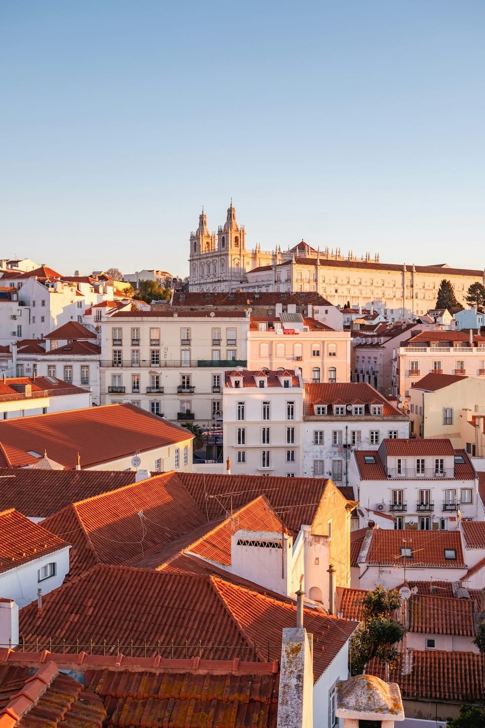 Terracotta rooftops and church towers in Alfama, Lisbon, Portugal